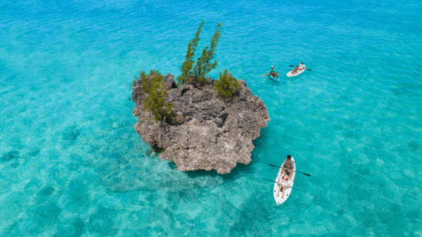 Crystal rock with kayaks paddling around